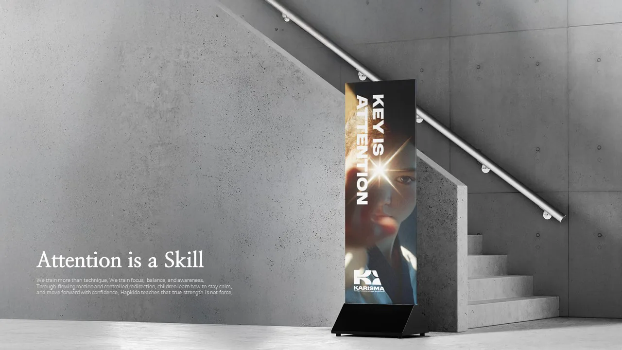 ‘Attention is a Skill’ 문구와 세로형 브랜드 배너가 배치된 회색 계단 공간의 연출 이미지